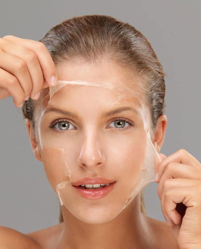 A clinician applying a chemical peel to the face